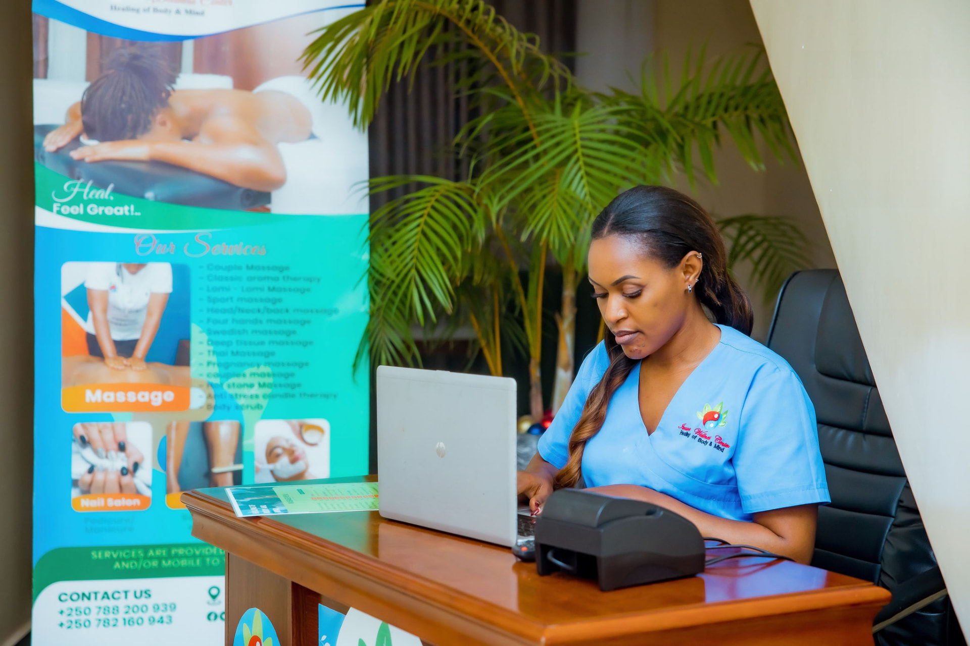 Oolala Wellness Center reception desk with the service menu banner